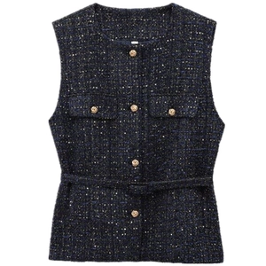 Detail of dark blue tweed vest featuring gold embossed buttons and a matching waist belt