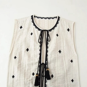 Bohemian white sleeveless V-neck top with black diamond embroidery and tassel drawstrings