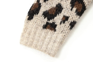 Detailed macro shot of leopard print knit sleeves with soft textured ribbed cuffs