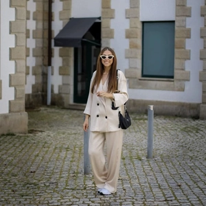 Chic beige two-piece double-breasted blazer and wide-leg trousers suit for women