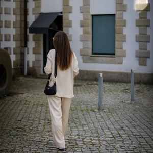 Women's cream white double-breasted blazer and trousers set in soft knit fabric back view