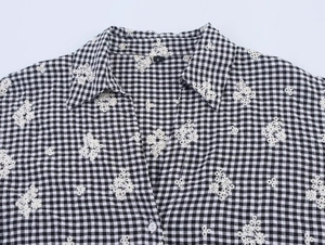 Detail of Gingham collar with floral embroidery and white button on S size shirt
