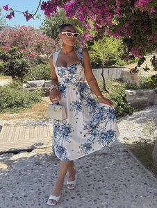 Detailed view of floral print dress with halter neckline and matching waist belt