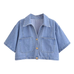 Detailed close-up of light blue washed denim cropped jacket with gold buttons