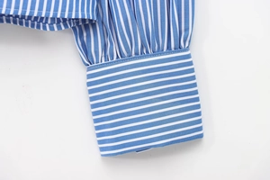 Detail shot of the pleated cuffs on a blue and white striped cotton shirt for women