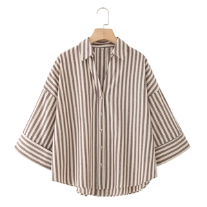 Linen blend loose vertical striped shirt with lapel collar and folded cuffs on wooden hanger