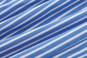 Macro shot of blue and white striped cotton fabric texture with pleated detail
