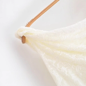 Elegant one-shoulder white lace top featuring intricate hollow embroidery and floral texture