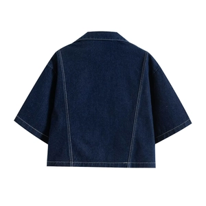 Detail view of dark blue denim jacket back featuring white contrast stitching and dropped shoulders