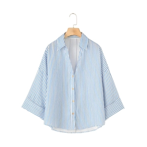 Detail of linen-blend shirt featuring blue vertical stripes and natural wood buttons