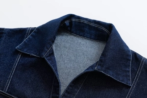 Close-up of dark blue denim jacket collar with contrast white stitching and twill texture