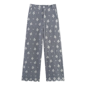 Detail of gingham wide-leg pants with floral embroidery and scalloped hemline
