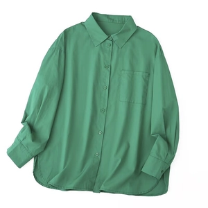 Close-up of bright green cotton-blend shirt featuring classic collar and square chest pocket