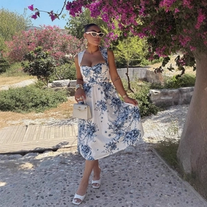 Floral print halter neck midi dress with belt and matching accessories in garden setting