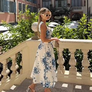 Women's summer floral halter neck midi dress with blue flower print on white background