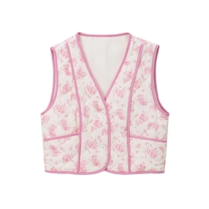 Detail view of pink floral quilted vest featuring white buttons and contrast piping