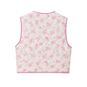 Detail view showing quilted floral pattern and pink bound edges on the white vest back