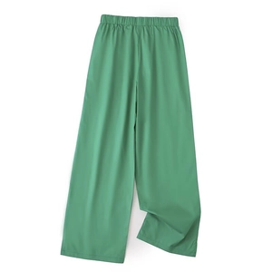 Detailed flat lay of green wide-leg trousers featuring an elastic waist and smooth fabric