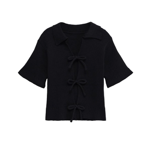 Women's black short sleeve knit polo top with elegant bow tie closures and ribbed edges