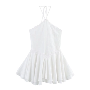 Detailed view of white halter neck dress with delicate V-shaped lace trim and textured fabric