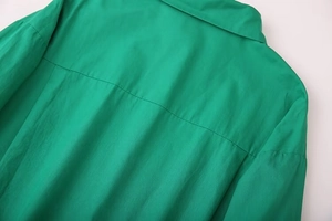 Detail view of emerald green shirt featuring back yoke seams and textured twill fabric