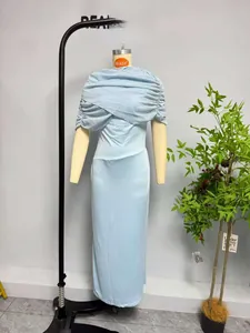 Detail of light blue mesh patchwork sleeveless dress featuring elegant pleated shawl design