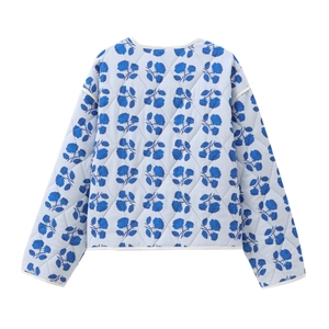 Women's light blue quilted jacket with blue rose floral print and white piping detail