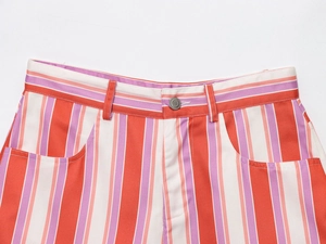 Detail of high-waisted striped shorts featuring colorful vertical lines and a metal button