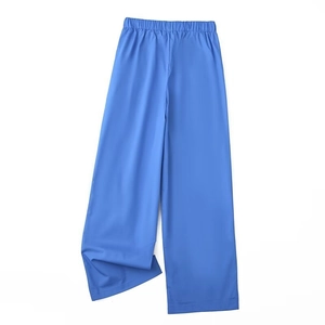 Detail of royal blue wide-leg trousers with elastic pleated waistband and silky texture