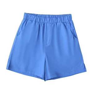 Detail of light blue casual shorts featuring elastic high waist and side split hem detail