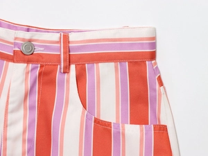 Detail of high waist vertical stripe shorts with silver button and side pocket feature