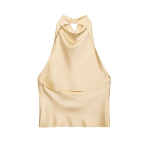 Detail view of the champagne satin halter top showing draped cowl neck and silky fabric