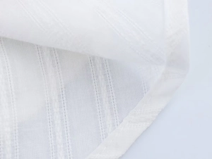 Detailed macro view of white lightweight breathable cotton fabric with vertical stripe texture
