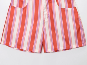 Detail view of vertical orange and purple stripes on high-waist cotton shorts with front pockets