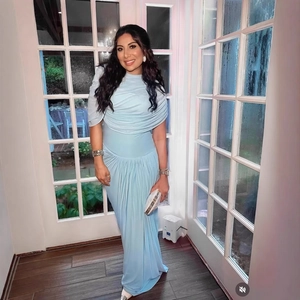 Elegant light blue long-sleeved dress with pleated design and tiered cape neckline