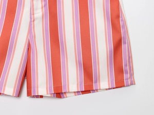 Close-up of multicolor vertical stripes on casual twill fabric shorts for women