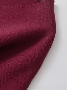 Close-up of wine red ribbed knit fabric showing soft texture and premium weave detail