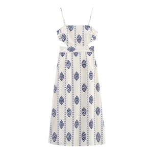 Detail of white midi dress featuring waist cut-outs and blue Persian floral embroidery