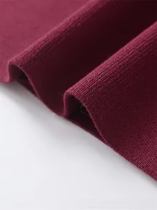 Macro shot of dark red knit cardigan showing fine texture and premium needlework details