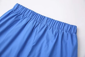 Detail view of electric blue trousers featuring a high-quality elastic waistband design