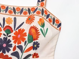 Close-up of bohemian floral print and cotton-linen texture on a summer dress