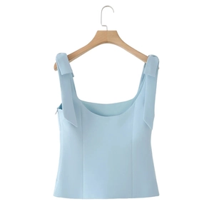 Detailed view of light blue sleeveless crop top with bow straps and invisible zipper
