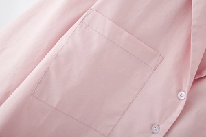 Close-up of pink casual shirt featuring a square patch pocket and white buttons detail