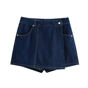 Minimalist dark blue denim skort for women featuring an asymmetrical wrap and metal button