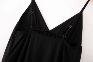 Detail of adjustable straps and invisible side zipper on a black V-neck midi dress