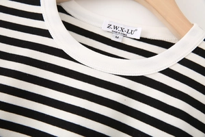 Close-up of crew neck collar with black and white horizontal stripes and size M label
