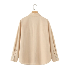 Back view of a loose-fitting beige linen shirt with dropped shoulders and back seams