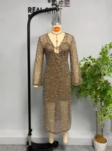 Detail of a sparkling gold sequin dress featuring a deep V-neckline and slim fit design