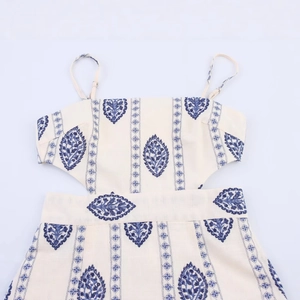 Bohemian midi dress with blue ethnic embroidery and stylish waist cut-outs on off-white