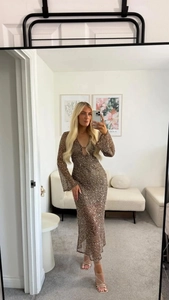 Detailed view of shimmering sequins on deep brown V-neck maxi dress for women